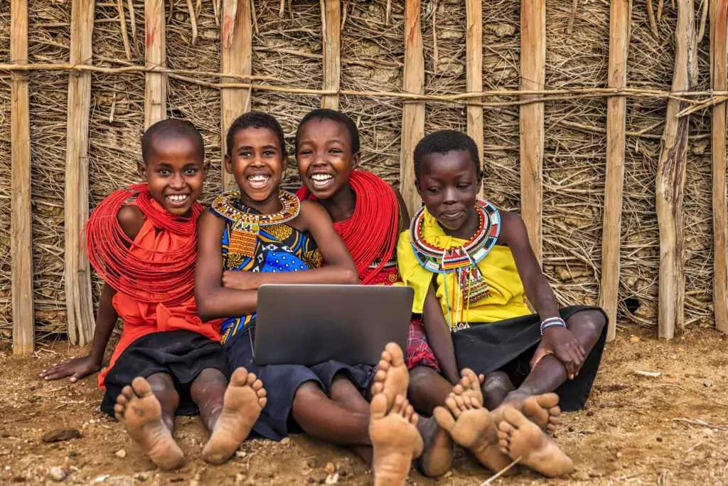 Children learning with a laptop outdoors